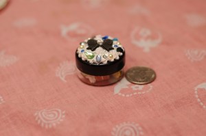 I painted the lid of this container to mimic the one made below. The bow and black motif is actually kinda classy looking, for what these are, anyways. 