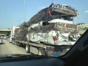 Saw this on the way to Wicked.  Can anyone please explain to me the purpose of transporting smashed cars somewhere?!