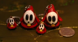 These are Shy Guys from Super Mario Brothers. The original shy guy is pretty cute, but these are just plain creepy in my opinion. Their creepiness makes them cool, though. 