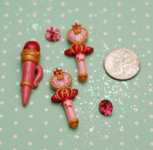 On the left is Sailor Moon's Disguise Pen. Very easy to make. :D  The two wands are Sailor ChibiMoon's Pink Moon stick.