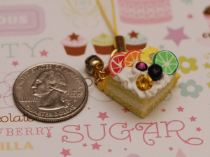 This is a cake charm with cane slices, in a quasi rainbow pattern.