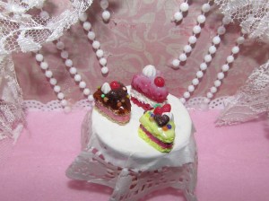 These are some colorful cakes I made at work. I am trying a new method for the texturing that hopefully makes them look more realistic. They are tiny charms, smaller than a quarter.