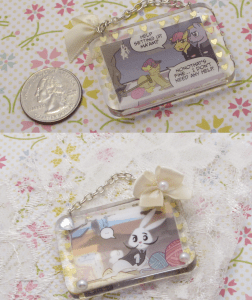 This is the first double sided resin piece I've made. It is cut from a comic book and suspended in resin with little confetti hearts as a border. 