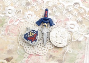 These are Link's Sword and Shield from the Legend of Zelda franchise. They were equally challenging to craft. I muse have re shaped the shield 10 times before settling on this incarnation! Oh my gosh, it was so frustrating. Y'all should have seen the first sword that I smashed back into a ball xD It looked so janky that I angrily smushed it up too. After 2 cups of coffee and some breathing exercises, these 2 finished products emerged, and I was pleased. *cue sigh of relief* 