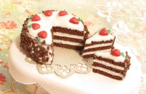 This cake.... I don't even know about this cake sometimes. I really wanted to make something with chocolate sprinkles, so I did. Then I really wanted it to have strawberries, so it does. Now that it's finished, it looks like some alternate dimension carrot cake O_o. To top it all off, somehow the frosting cracked on the big part. Like I said, I don't even know. This cake is totally not going up for sale, unless, you know, someone really falls in love with it haha.